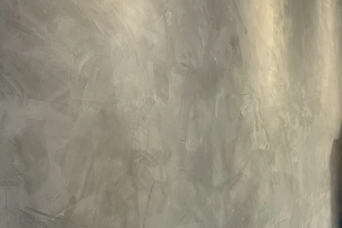 Parede cinza com acabamento decorativo destacado pela iluminação