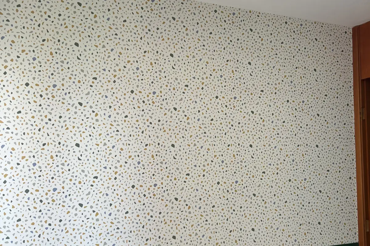Papel de parede com padrão de granilite aplicado acima de uma meia parede verde